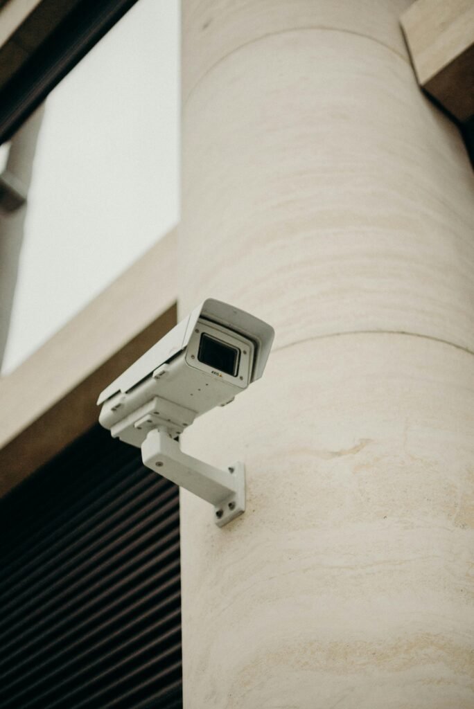 pexels-photo-3205735-3205735 Close-up of a CCTV camera on a concrete building, symbolizing security and technology.