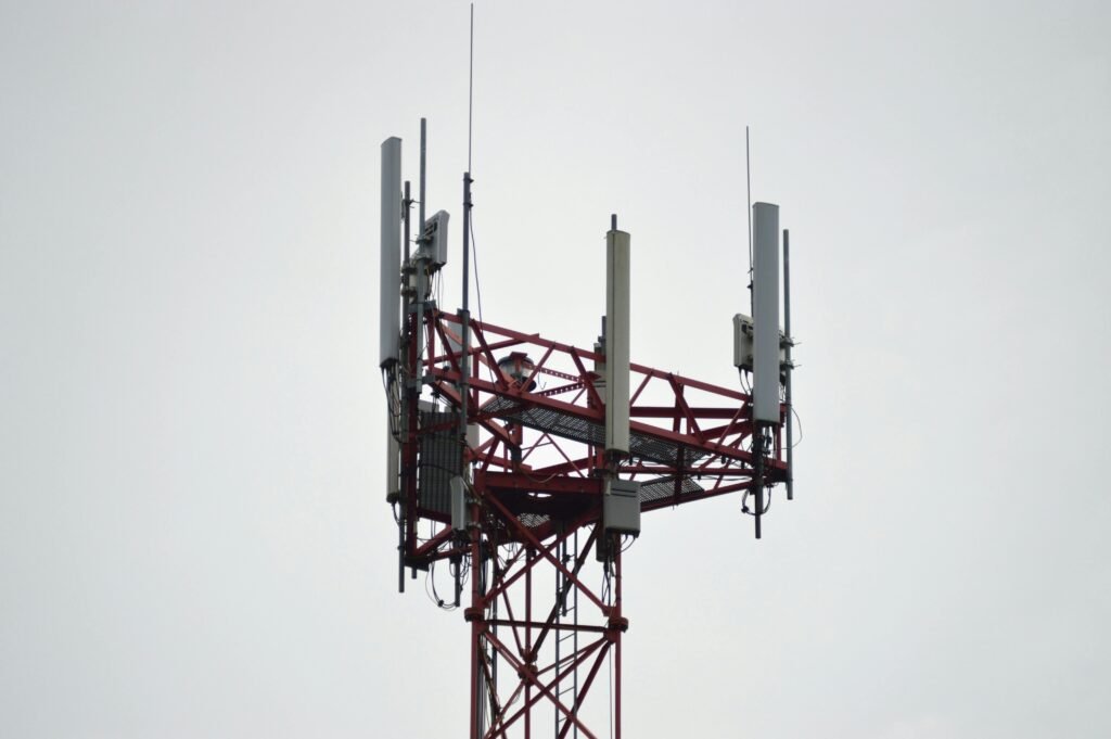 pexels-photo-579471-579471 A red communication tower with antennas stands tall against a gray sky.